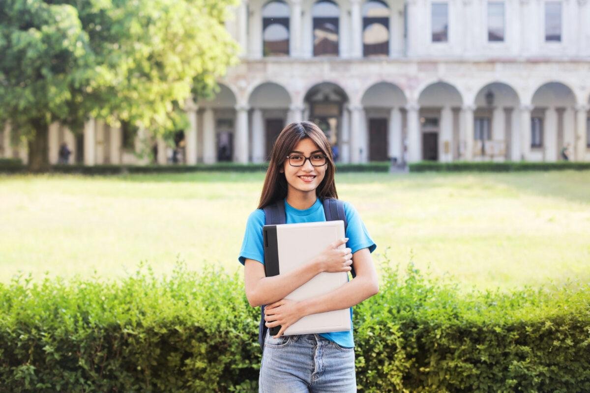 A you student standing in front a top university.